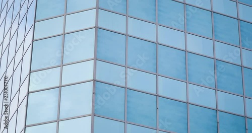 Wallpaper Mural 4k time lapse shot with vertical tilt of a glass office building facade reflecting moving clouds. Torontodigital.ca