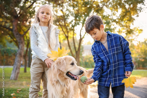 Cute children with dog in autumn park © Pixel-Shot