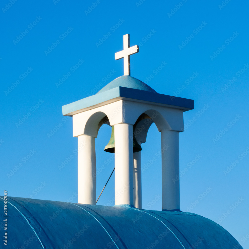 Church bell and cross, Church of Saint Nicholas, Pollonia, Milos, Greece Church bell and cross, Church of Saint Nicholas, Pollonia, Milos, Greece