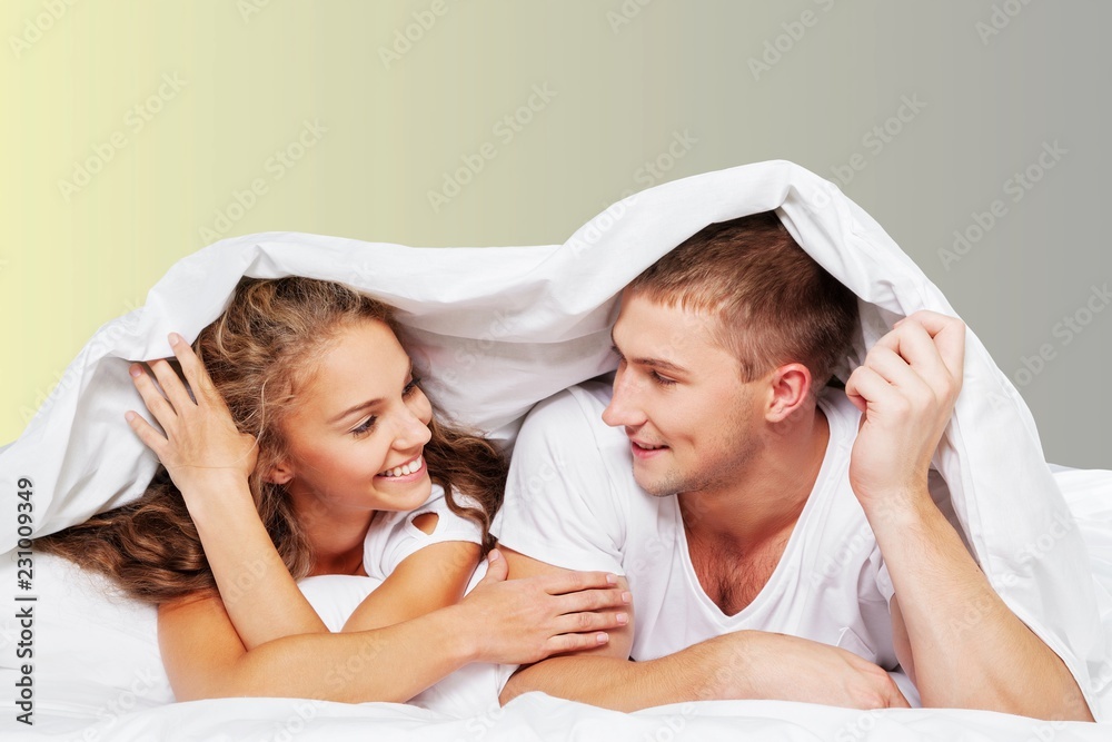 Young beautiful couple in bed at home Young beautiful couple in bed at home