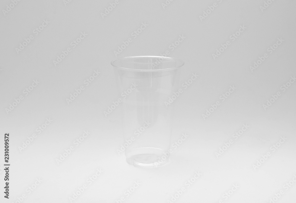 plastic water glass on pale grey background plastic water glass on pale grey background