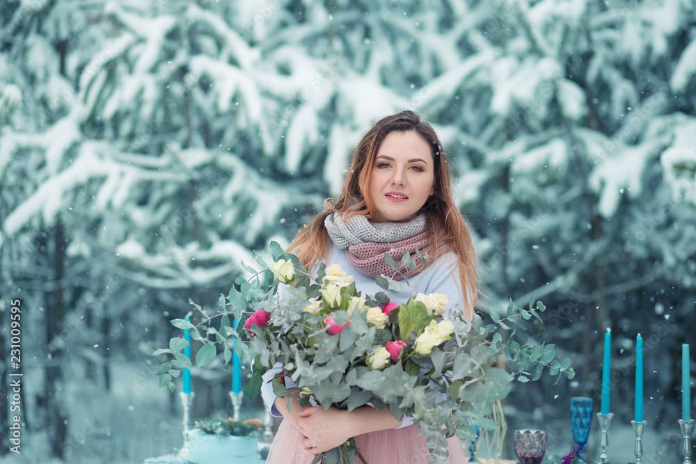 Beautiful girl on the background of the winter forest.