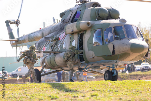 Military helicopter lands on the ground during Military Exercise