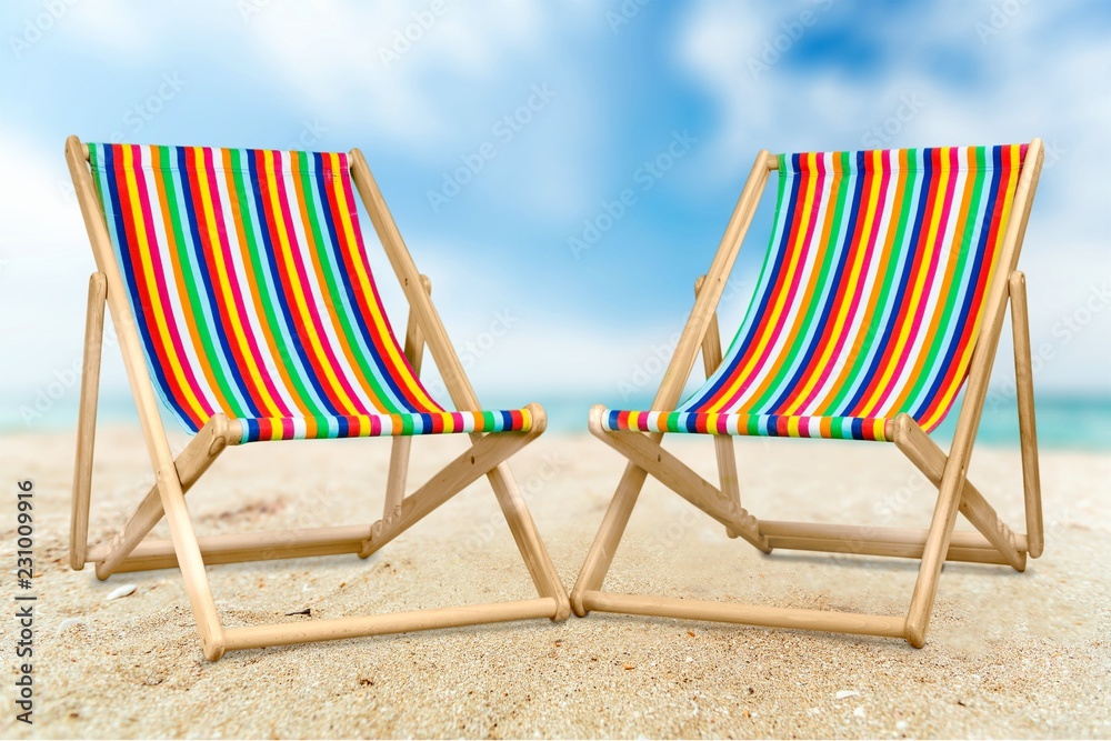 Colorful Chair with female hat on sandy