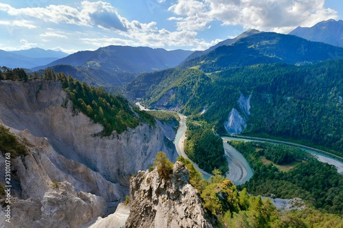 View from the viewing platform Il to the limestone cliffs at a river loop of the Vorderrhein, Ruinaulta or Rhine Gorge, Flims, Canton Graubunden, Switzerland, Europe photo