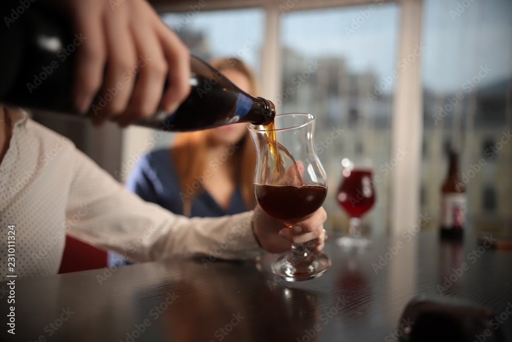 Pouring craft beer from the bottle in the glass