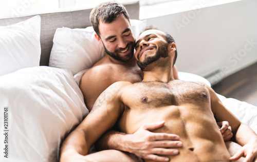 A Handsome gay men couple on bed together photo