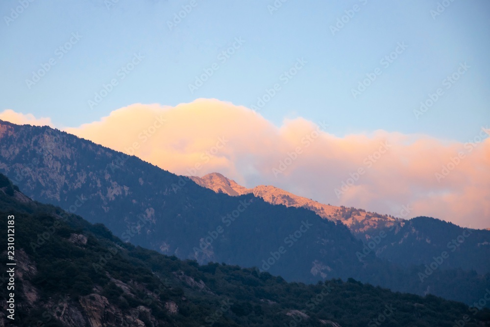 sunset in mountains, rose cloud in the sky