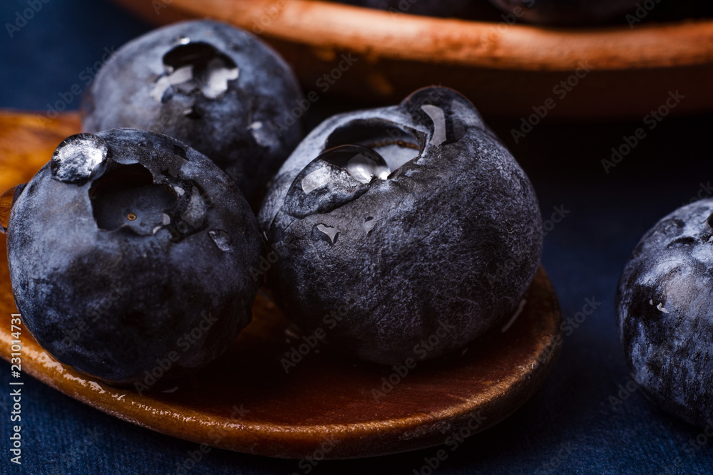 bog whortleberry in a wooden spoon. macro photography bog whortleberry in a wooden spoon. macro photography