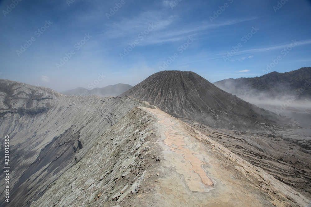 Insane landscape of the Mount Bromo crater rim, Mount Batok, and a dust storm in the Sea to Sands in East Java, Indonesia