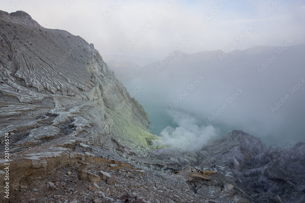 Smoky morning inside the crater of Mount Ijen in East Java, Indonesia