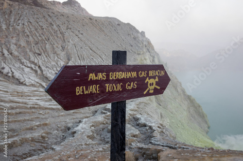 Sign bewaring hikers of the toxic dangers at the sulfur pits within the crater of the Mount Ijen volcano in East Java, Indonesia photo