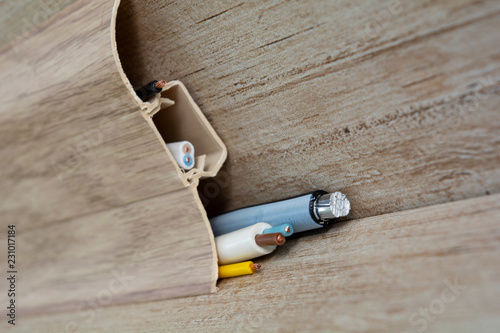 Tela stripped wires protrude from the floor skirting