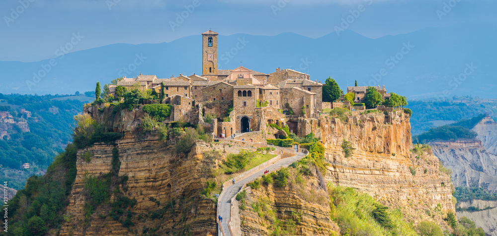 Fototapeta premium The famous Civita di Bagnoregio hit by the sun on a stormy day. Province of Viterbo, Lazio, Italy.
