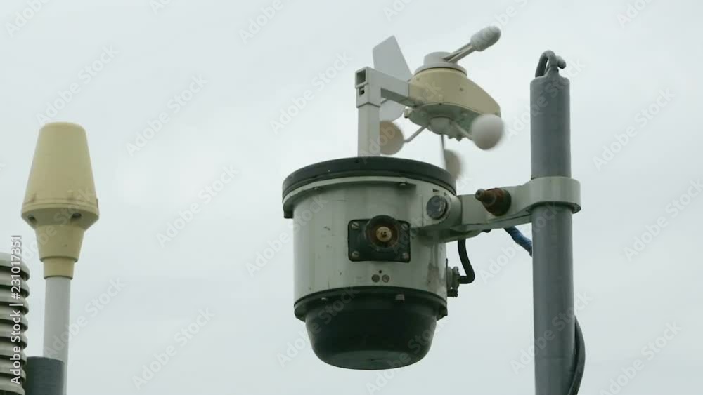 Weather vane rotates in the direction of the wind. Vane anemometer against the sky, on a ship board. Weather vane rotates in the direction of the wind. Vane anemometer against the sky, on a ship board.