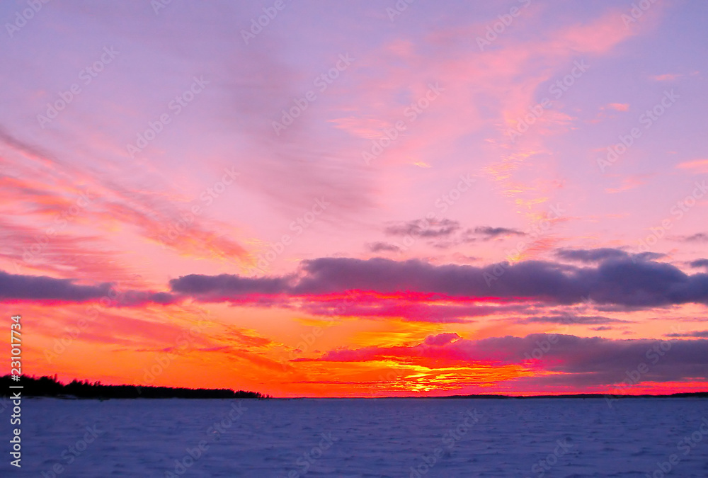 Winter sunset over frozen Baltic Sea in Finland