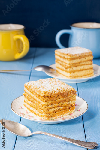 pieces of homemade honey cake on a blue table