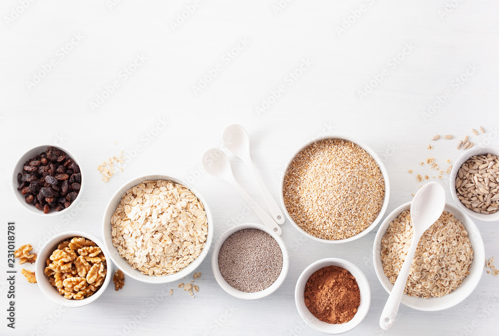 variaty of raw cereals and nuts for breakfast. Oatmeal flakes and steel cut, barley, walnut, chia, raisins. Healthy ingredients variaty of raw cereals and nuts for breakfast. Oatmeal flakes and steel cut, barley, walnut, chia, raisins. Healthy ingredients