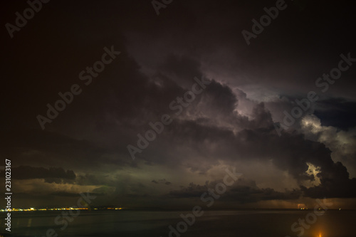 Thunderstorm over the sea, lightning beats the water