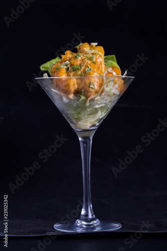 crispy shrimps, sauce on a glass