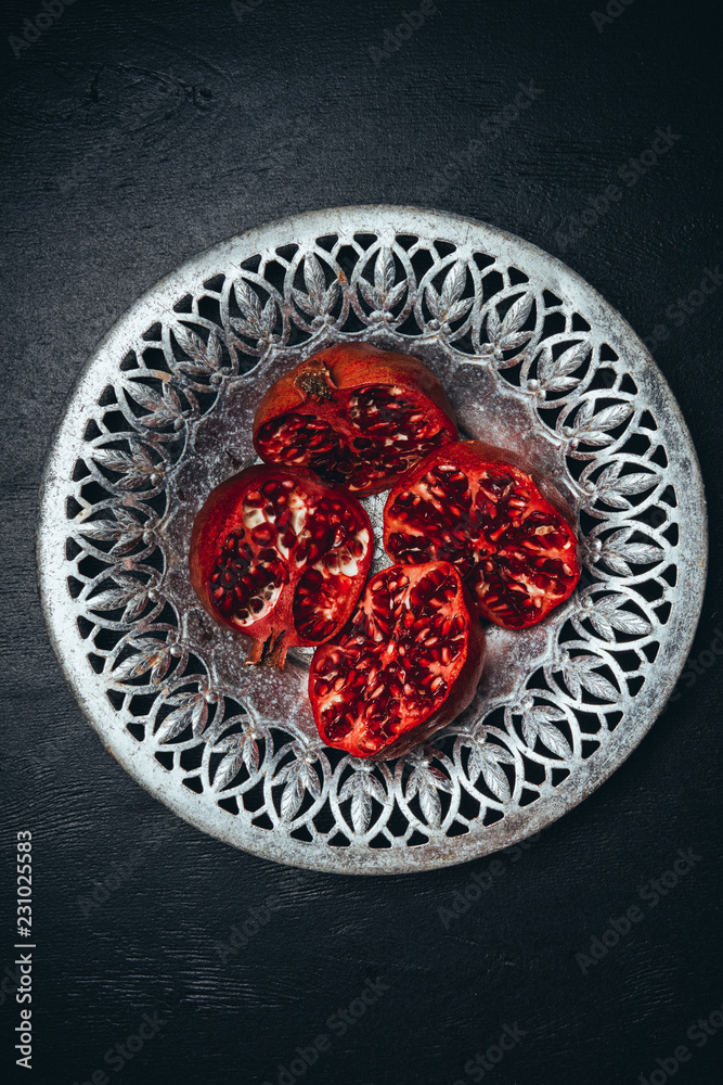 top view of fresh cut garnets in metal bowl on black surface top view of fresh cut garnets in metal bowl on black surface