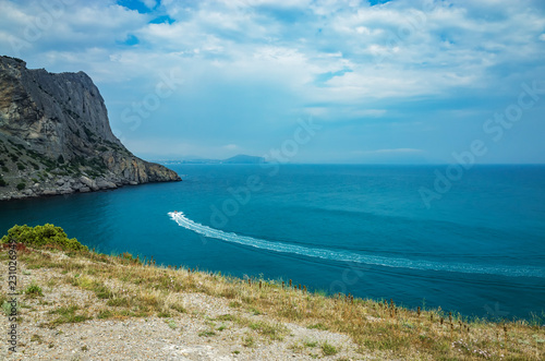 Boat in the bay among the mountain range, Sudak district, Crimea