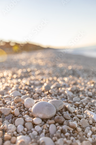 White pebble on the background of the sea beach at dawn © A_Skorobogatova