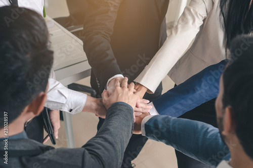 Teamwork power concept. Group of businesspeople stack hand together. © Pormezz