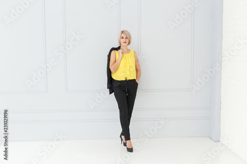 Fashion portrait of woman in yellow and black suit