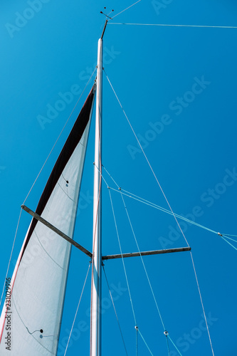 Sail of a sailing boat against blue sky