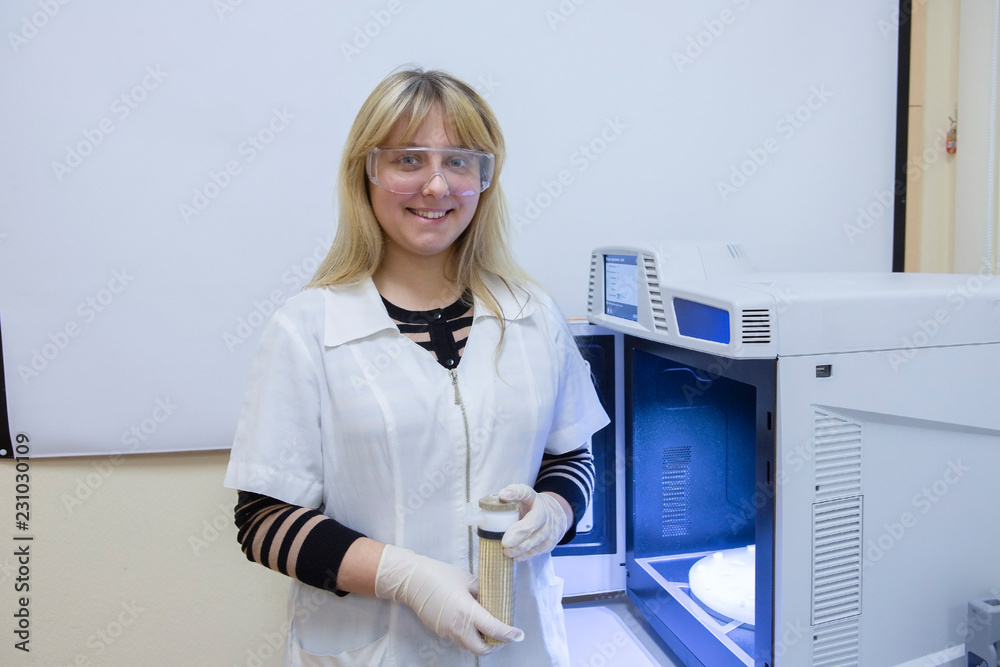 Female Laboratory Scientist Examining Sample In Test Tube Female Laboratory Scientist Examining Sample In Test Tube