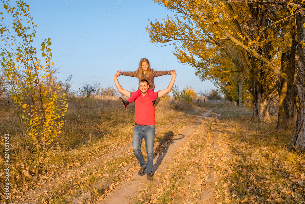 Happy father and child girl daughter on his shoulders Happy father and child girl daughter on his shoulders