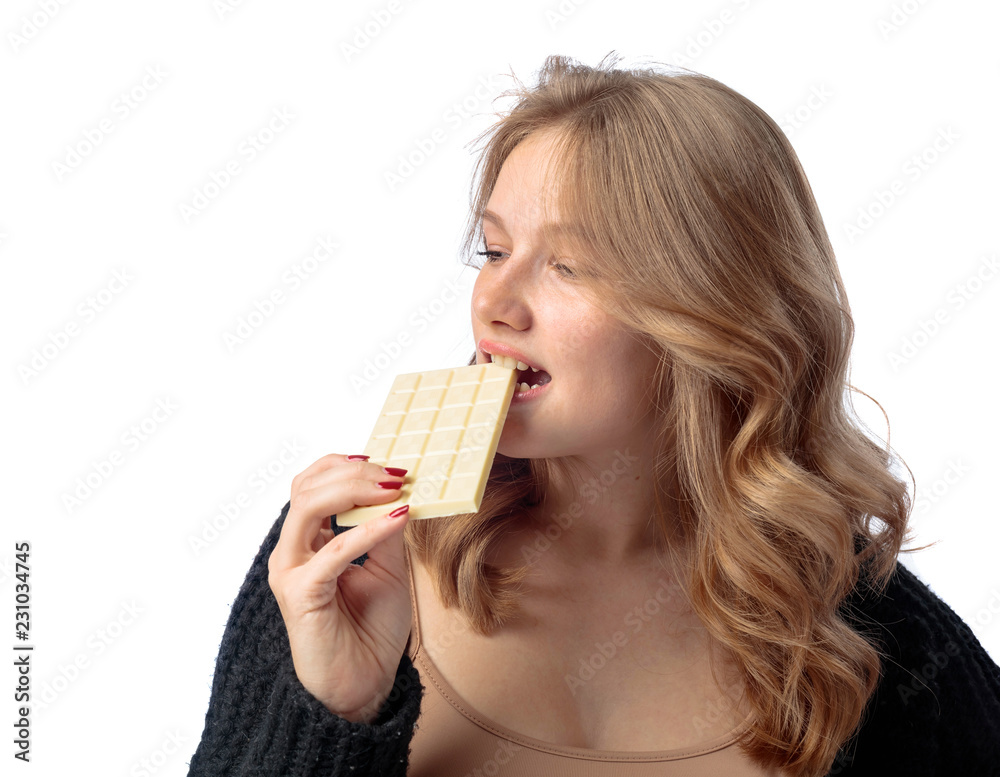 Happy young beautiful woman eating white chocolate. Happy young beautiful woman eating white chocolate.
