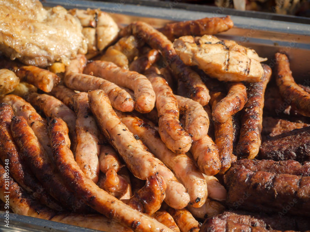 Various grilled sausages on a baking sheet. Street food. Various grilled sausages on a baking sheet. Street food.