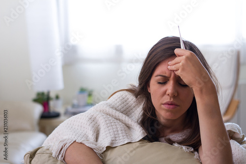 Murais de parede Young caucasian brunette ill woman with headache, belly pain, fever, with hands