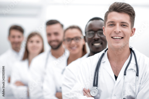 Team of smiling professional doctors standing together