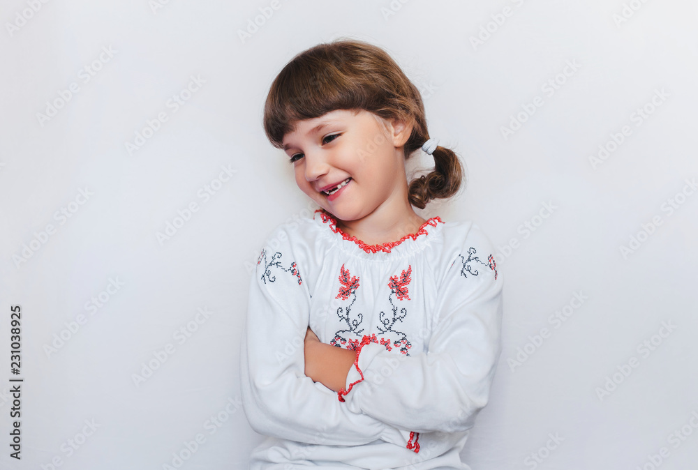 Cheerful little Ukrainian girl smiles sincerely. Children feel shy. Copy space. Cheerful little Ukrainian girl smiles sincerely. Children feel shy. Copy space.