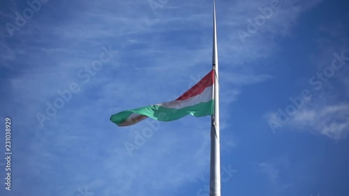 Budapest. Hungarian flag flutters in the wind in slow motion on blue sky see from bottom. Shot in Full HD.
