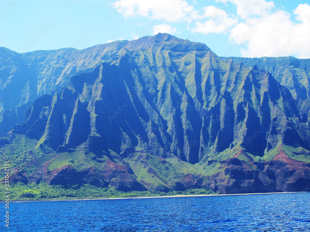 The amazing hawaiian mountains of the Napaili coast on a hot summer morning. View from the ocean. Kauai. Hawaii