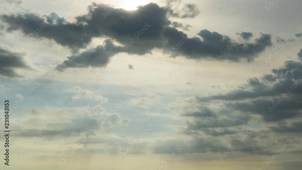 Dramatic stratocumulus gray puffy clouds reveals the sun in evening. Light beams break through the clouds. Timelapse footage of sunset. Dramatic stratocumulus gray puffy clouds reveals the sun in evening. Light beams break through the clouds. Timelapse footage of sunset.
