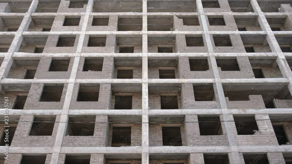 Multi-storey residential building under construction. Front view, camera moving up. Multi-storey residential building under construction. Front view, camera moving up.