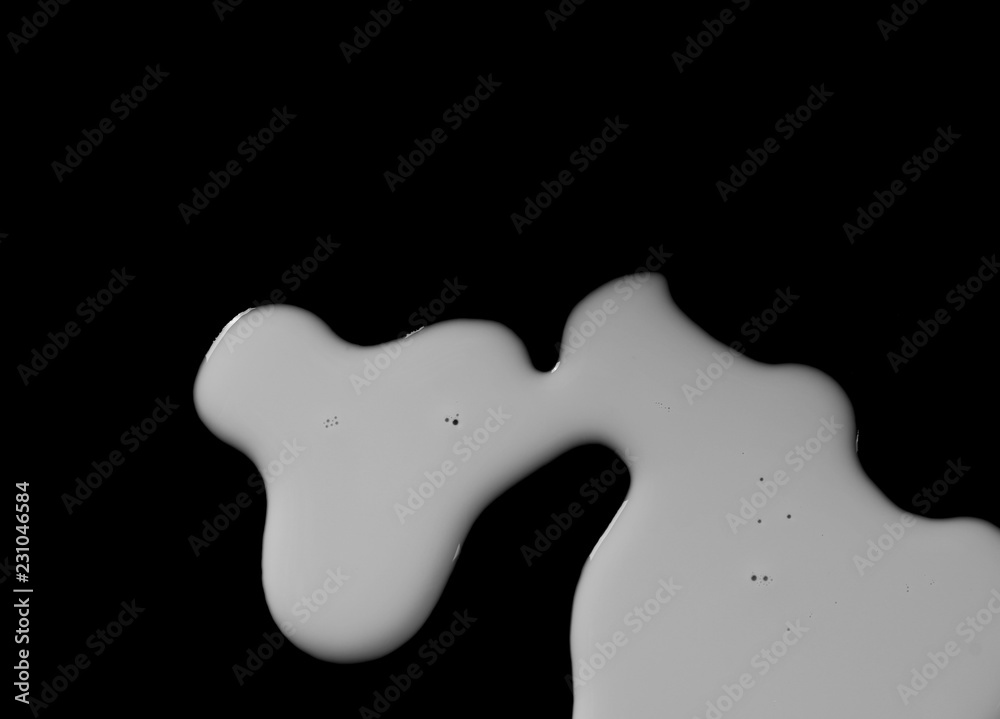 Spilled milk puddle isolated on black background and texture with clipping path, top view Spilled milk puddle isolated on black background and texture with clipping path, top view