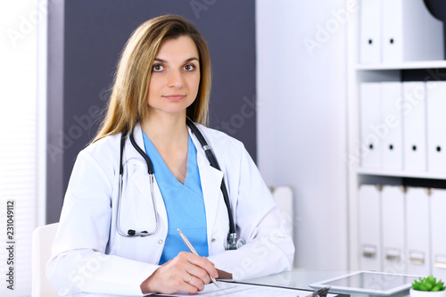 Woman doctor at work in hospital office. Portrait of female physician. Medicine and health care concept