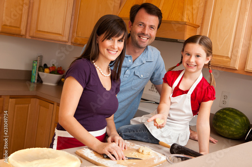 Happy Family Making Pie in Kitchen at Home