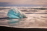 Aquamarine Glacier Remant Washed onto Black Sand in Iceland