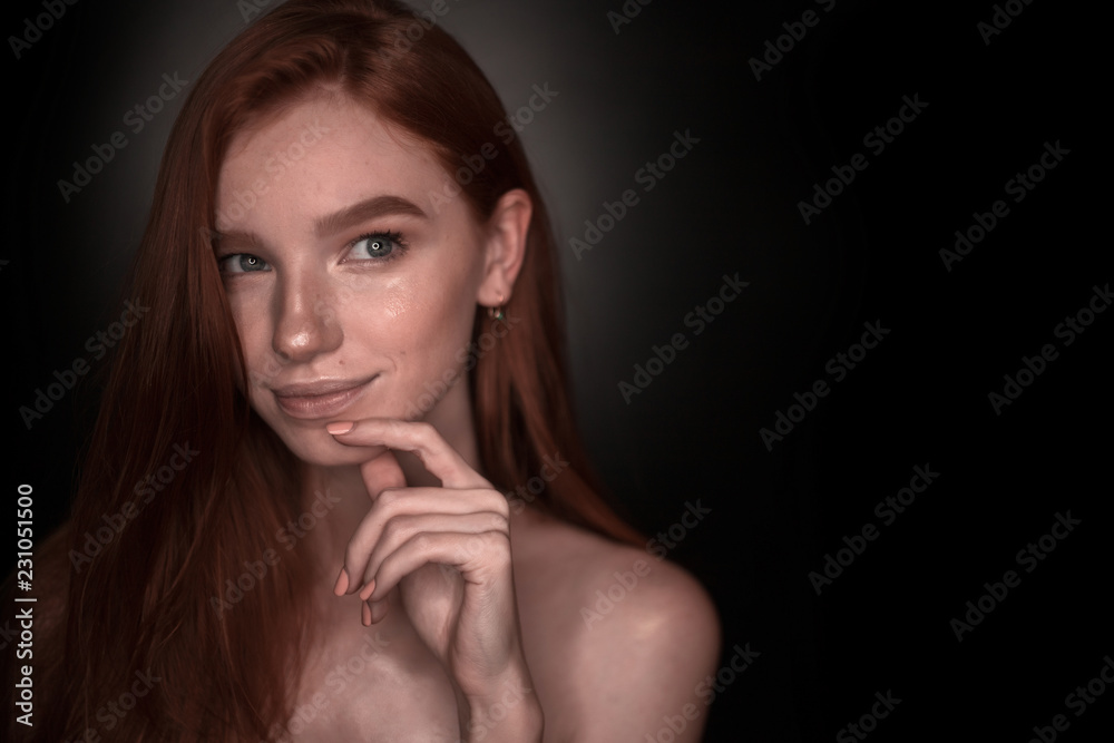 Thinking dreaming redhead girl woman with healthy glow wet skin posing isolated over black wall background looking aside to empty copyspace. Thinking dreaming redhead girl woman with healthy glow wet skin posing isolated over black wall background looking aside to empty copyspace.