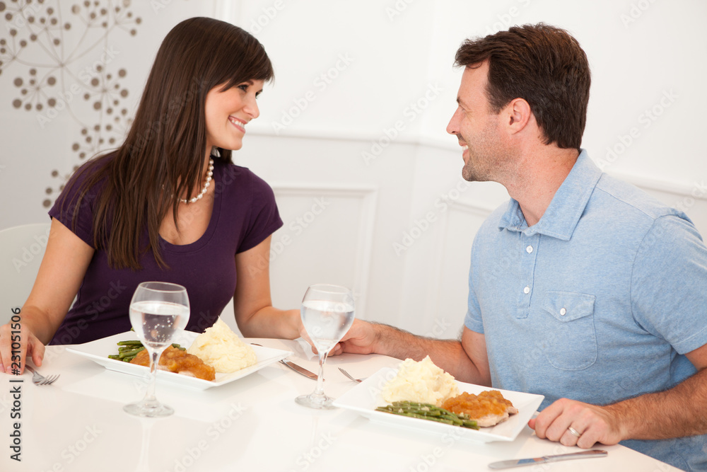 Young Couple Eating Dinner Together at Home Young Couple Eating Dinner Together at Home