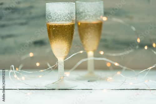 two glasses of champagne on background of lights