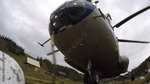 Takeoff of the helicopter on rough terrain. bottom view, the strong flow of the wind.