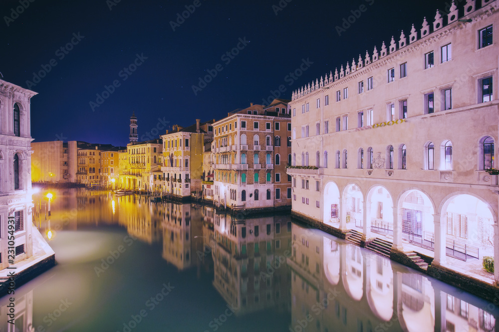 Venice - Grand Canal from Rialto bridge at night, Italy. Long exposure, Calm water surface. Venezia, Italia. 